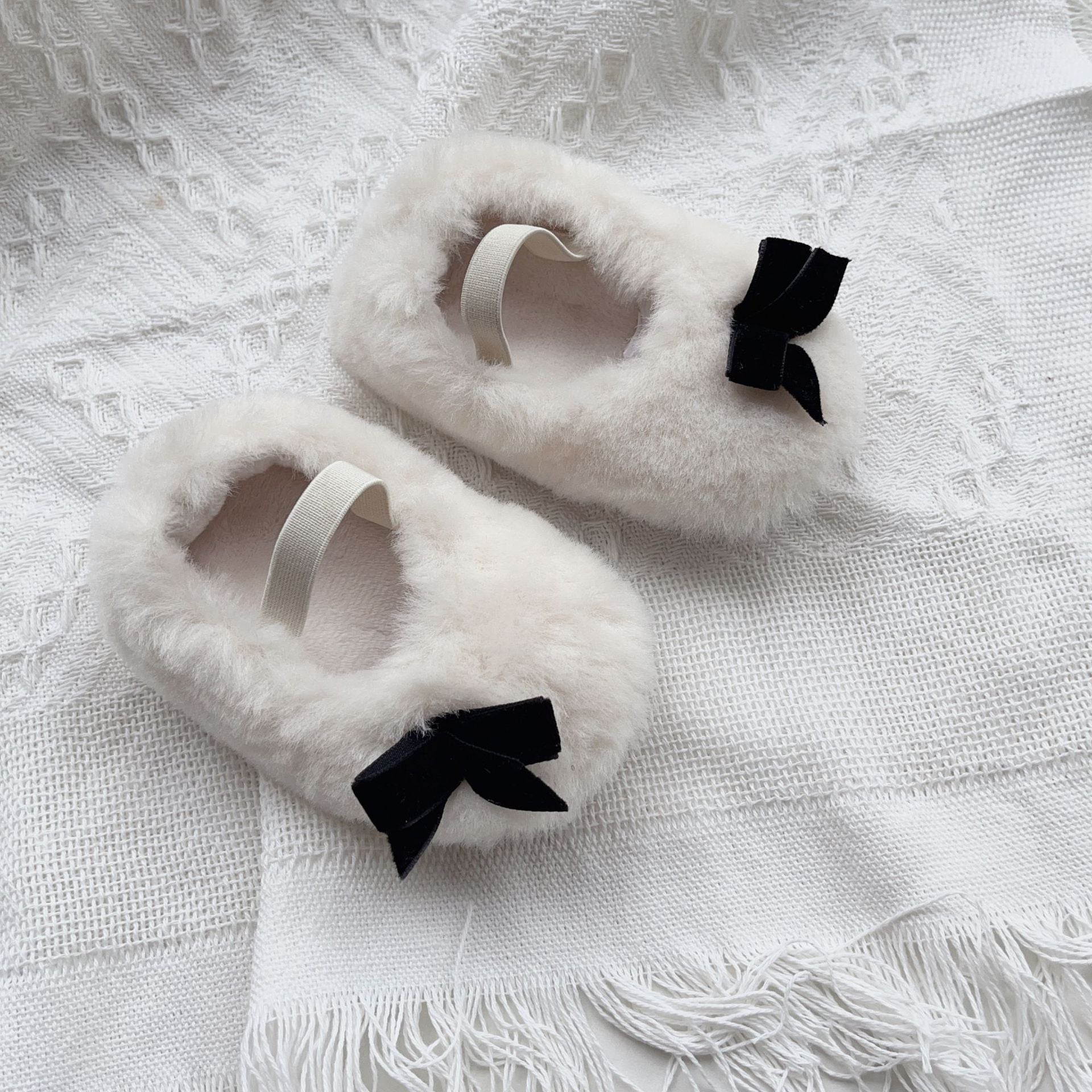 Cute Baby Girl Solid Color Combo Bow Tie Design Plush Warm Anti-Slip shoes in white, pink, and apricot colors, showcasing their soft material and anti-slip sole.