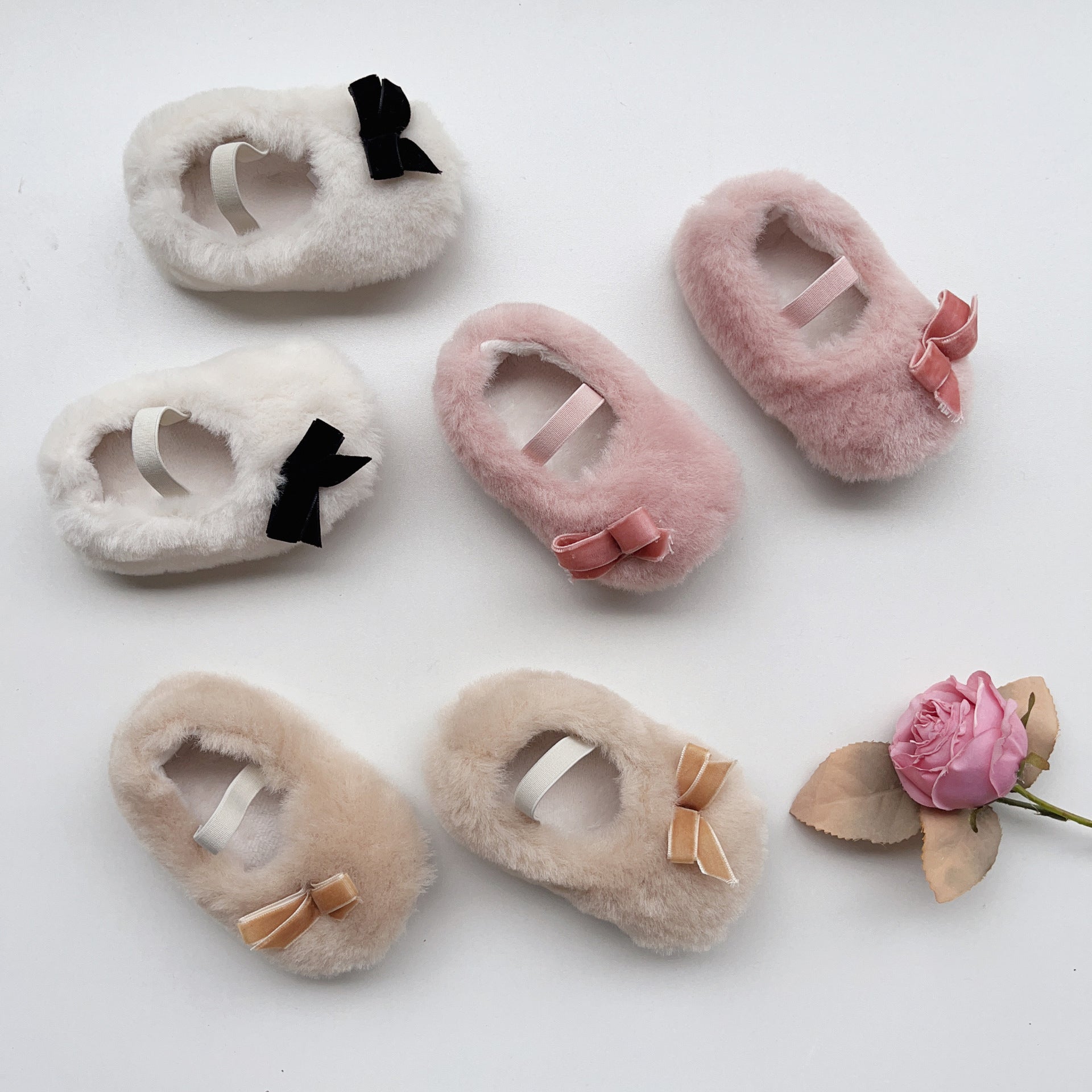 Cute Baby Girl Solid Color Combo Bow Tie Design Plush Warm Anti-Slip shoes in white, pink, and apricot colors, showcasing their soft material and anti-slip sole.