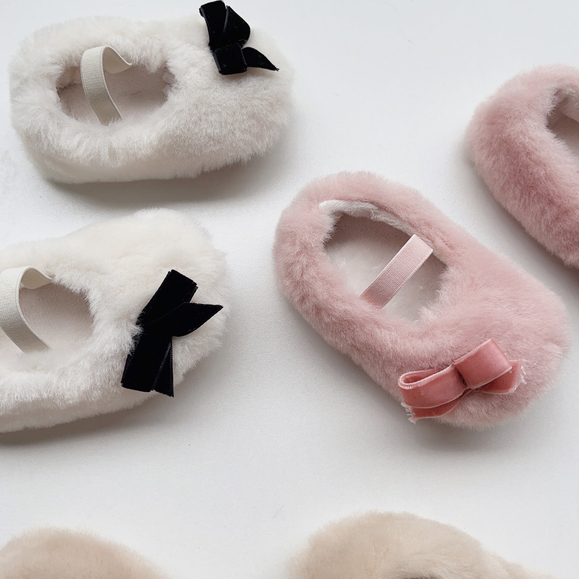 Cute Baby Girl Solid Color Combo Bow Tie Design Plush Warm Anti-Slip shoes in white, pink, and apricot colors, showcasing their soft material and anti-slip sole.