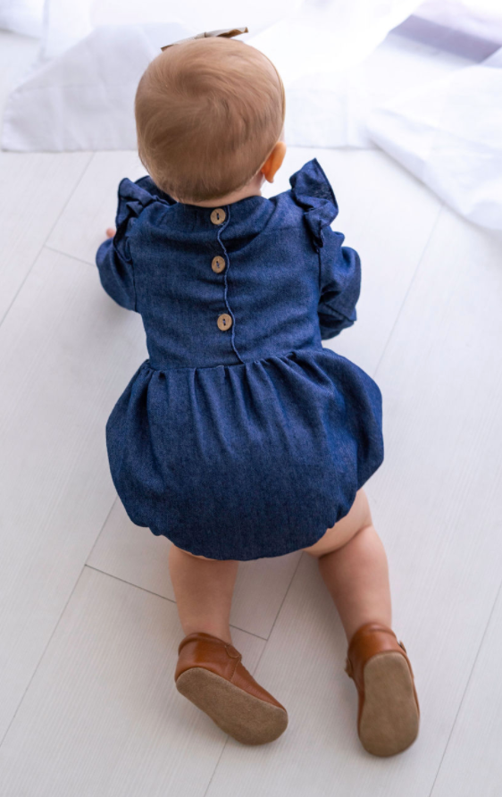 A stylish Denim Flutter Sleeve Romper for babies, featuring soft denim fabric and flutter sleeves, perfect for special occasions.