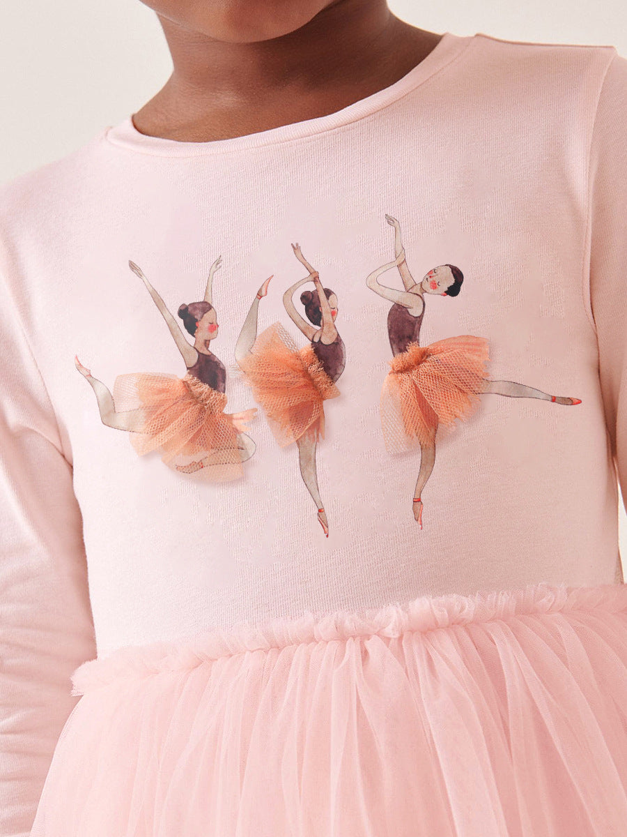 A pink long sleeve top featuring a cartoon dancer pattern, perfect for girls aged 12 months to 10 years.