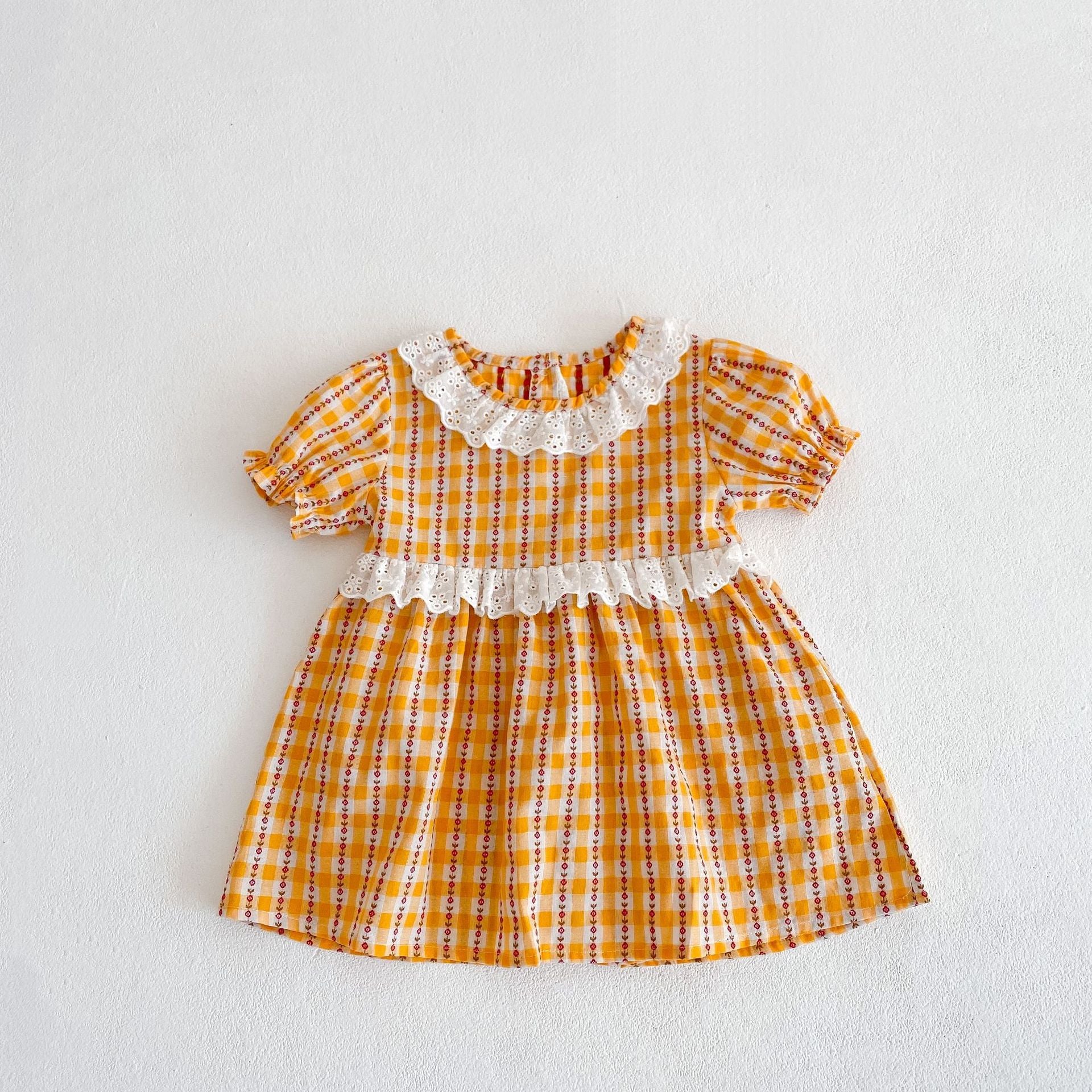 A vibrant yellow summer dress for girls featuring a hollow-out collar and floral striped patterns, perfect for warm weather.