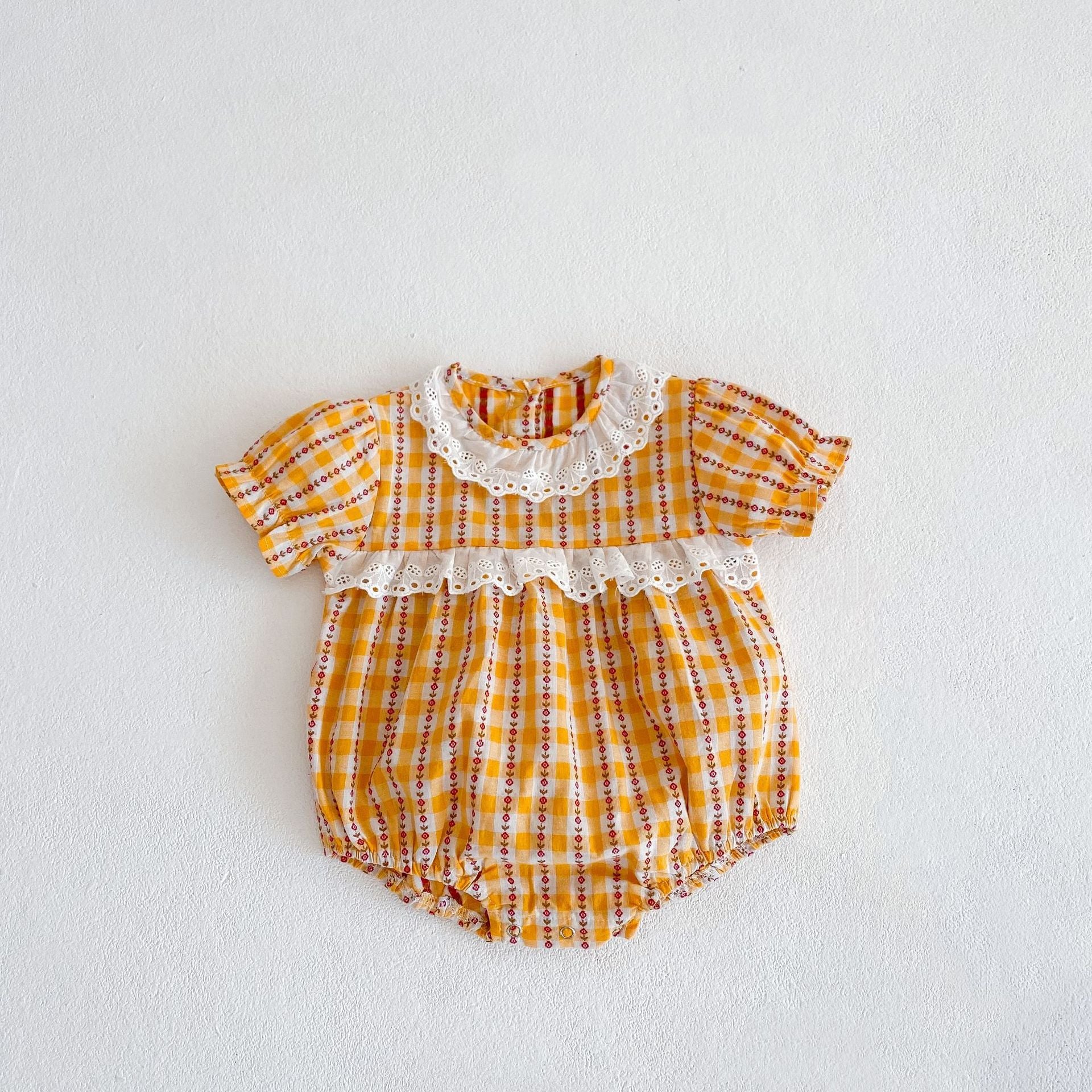 A vibrant yellow summer dress for girls featuring a hollow-out collar and floral striped patterns, perfect for warm weather.