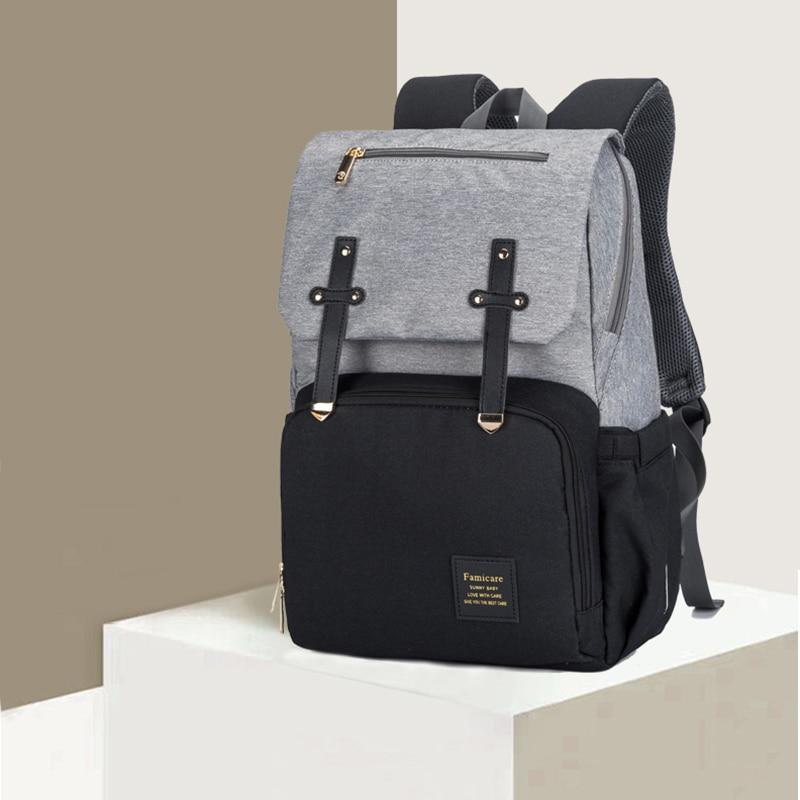 Stylish Diaper Bag Mummy Daddy Backpack in grey and black, featuring waterproof Oxford material and USB charging capability.