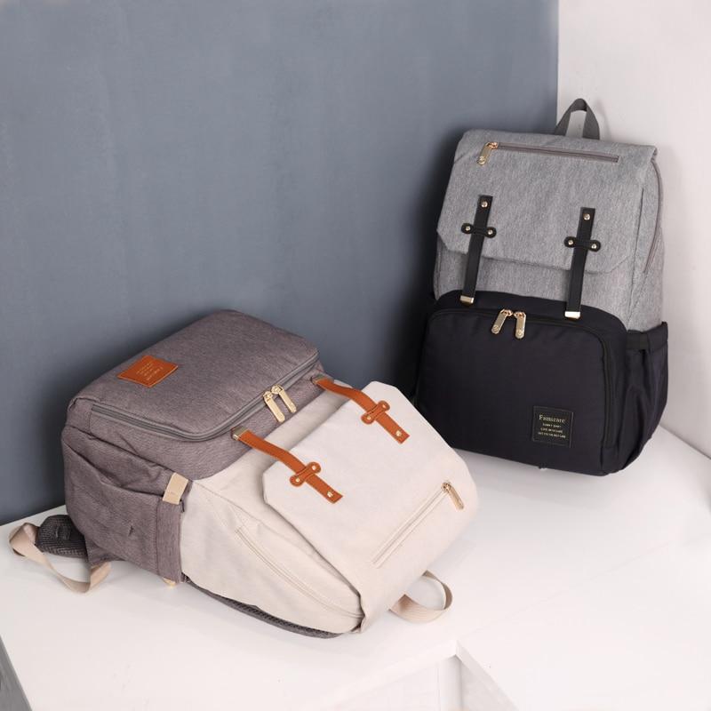 Stylish Diaper Bag Mummy Daddy Backpack in grey and black, featuring waterproof Oxford material and USB charging capability.