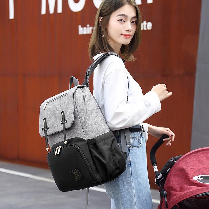 Stylish Diaper Bag Mummy Daddy Backpack in grey and black, featuring waterproof Oxford material and USB charging capability.