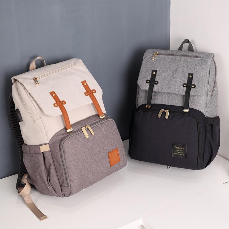 Stylish Diaper Bag Mummy Daddy Backpack in grey and black, featuring waterproof Oxford material and USB charging capability.