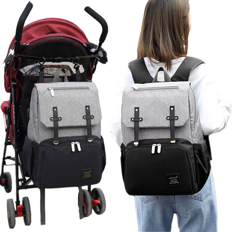 Stylish Diaper Bag Mummy Daddy Backpack in grey and black, featuring waterproof Oxford material and USB charging capability.