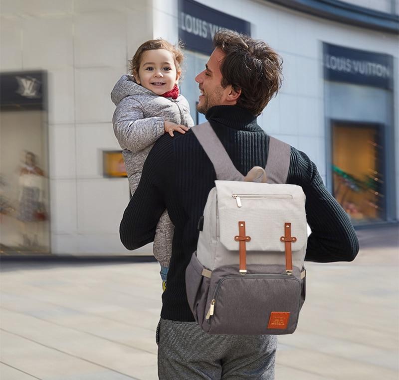 Stylish Diaper Bag Mummy Daddy Backpack in grey and black, featuring waterproof Oxford material and USB charging capability.