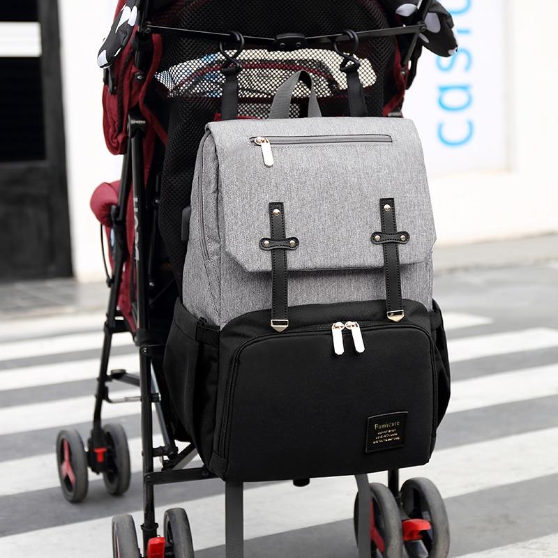 Stylish Diaper Bag Mummy Daddy Backpack in grey and black, featuring waterproof Oxford material and USB charging capability.