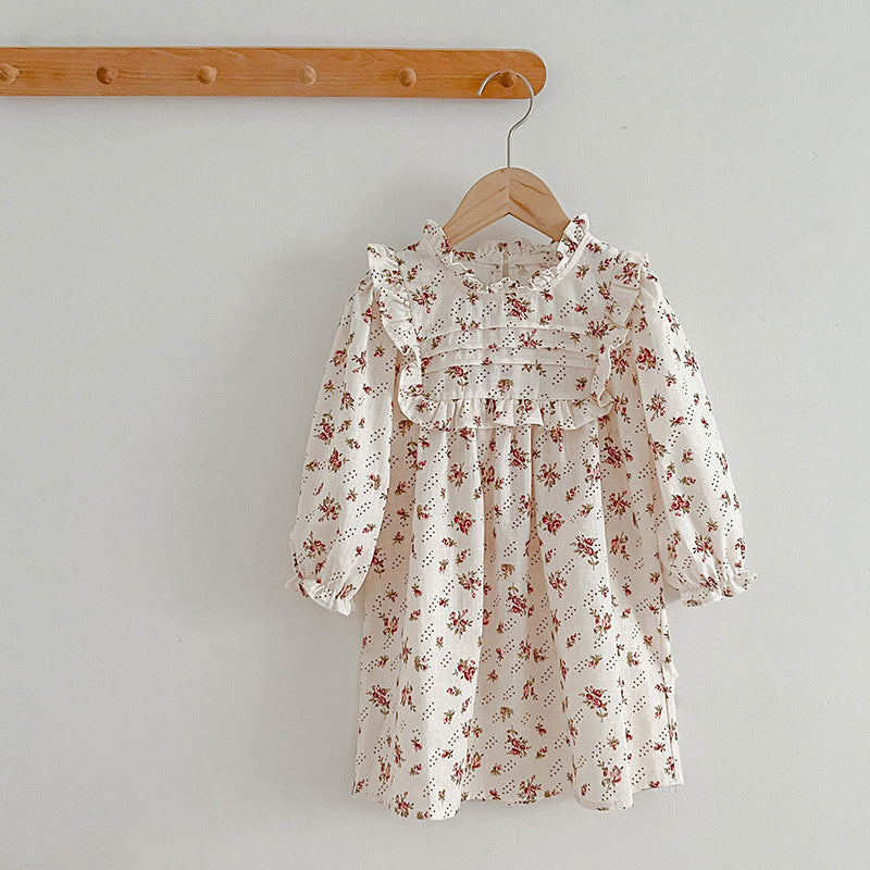 A collection of Ditsy Flower Graphic Sisterly Clothes, featuring floral onesies and dresses in white and red colors, made from soft cotton.