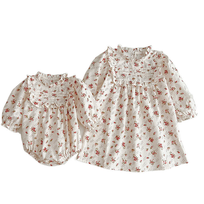 A collection of Ditsy Flower Graphic Sisterly Clothes, featuring floral onesies and dresses in white and red colors, made from soft cotton.