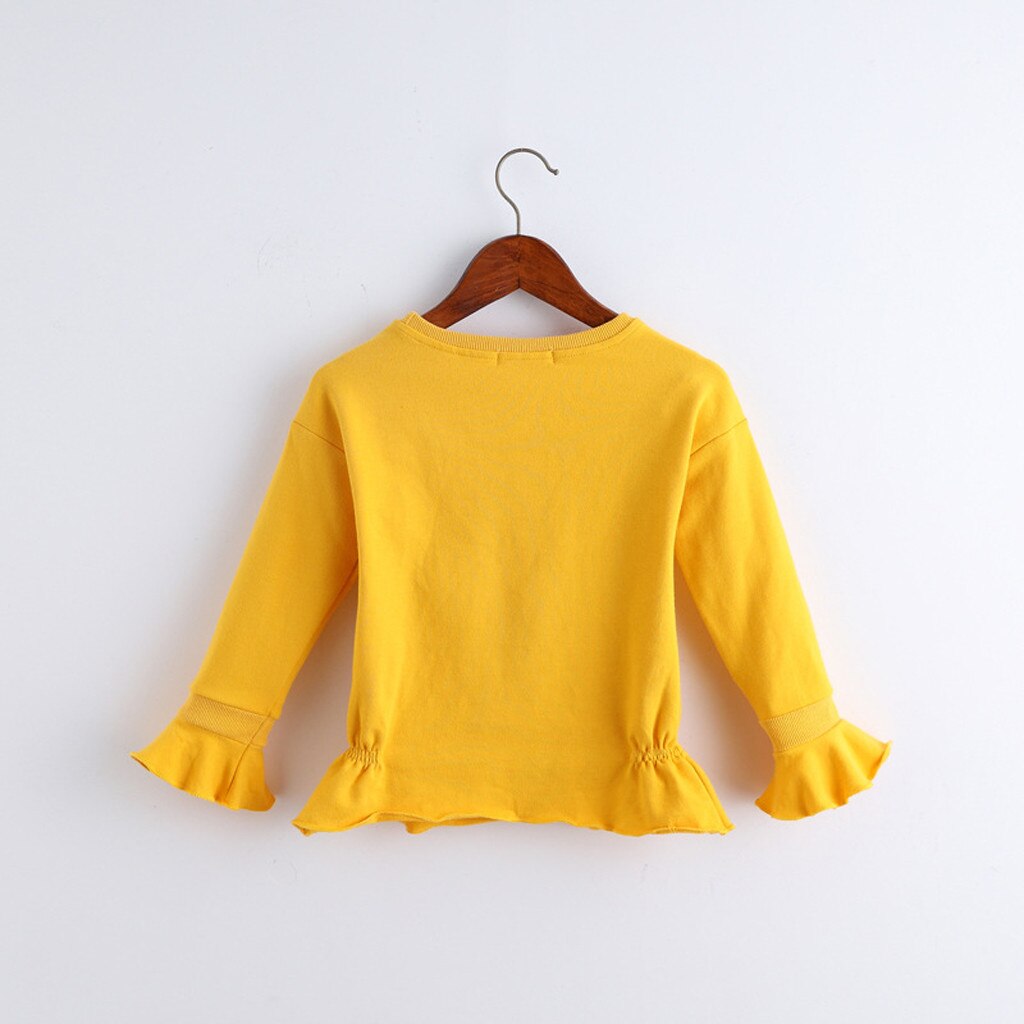 Yellow ruffled long-sleeve shirt.