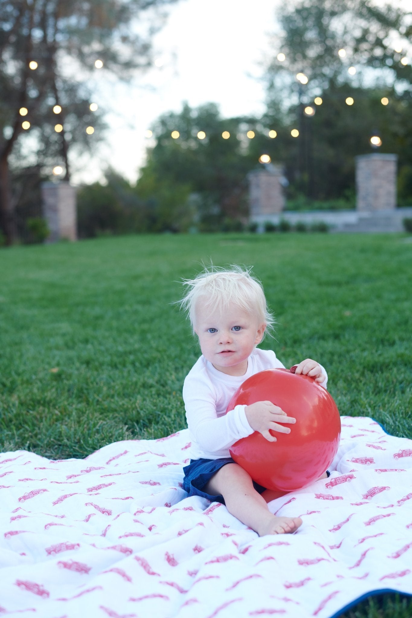 Cozy cotton muslin blanket featuring fire truck and Dalmatian designs, perfect for kids.