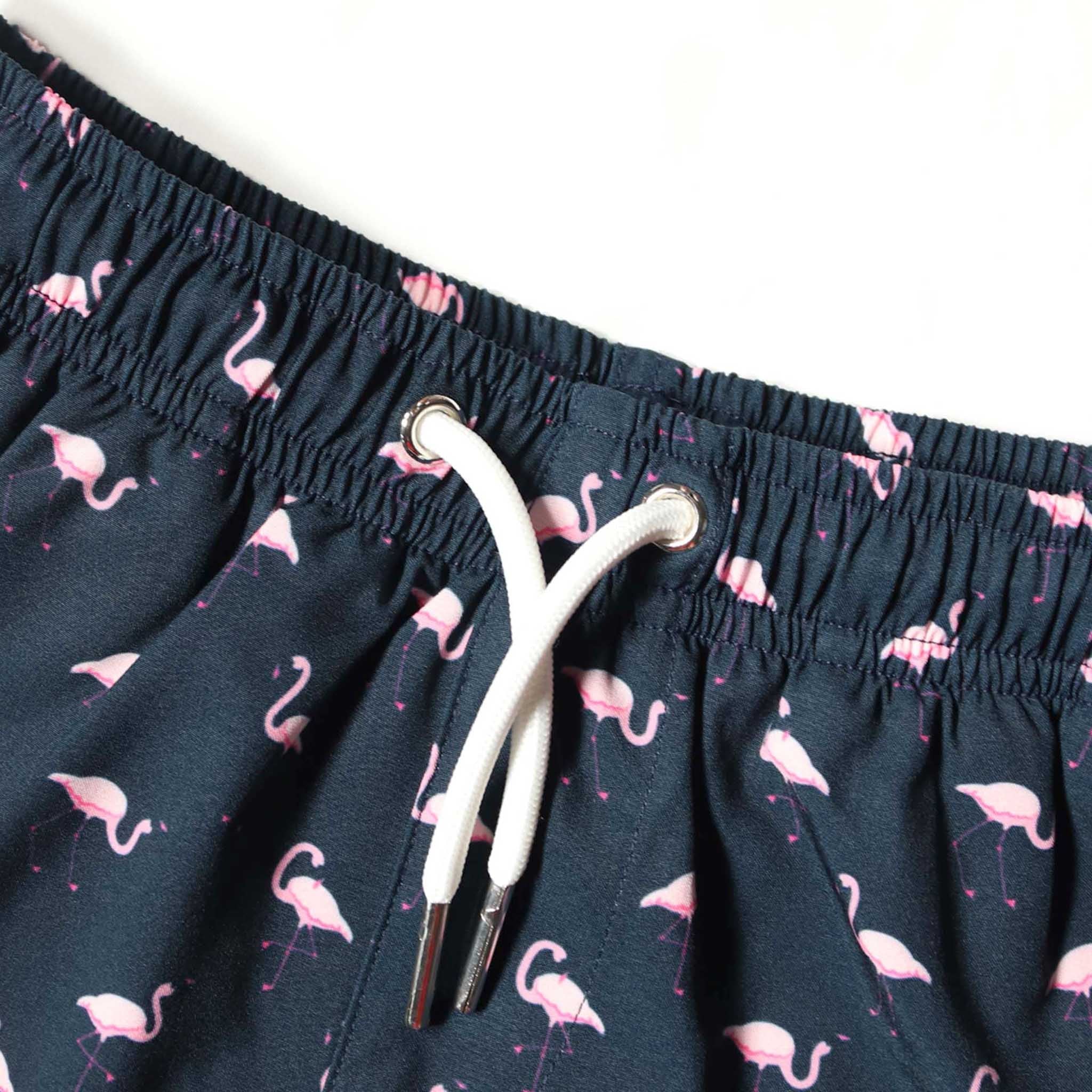 Flamingo Kids Swim Trunks featuring vibrant colors and a comfortable design, perfect for summer fun.