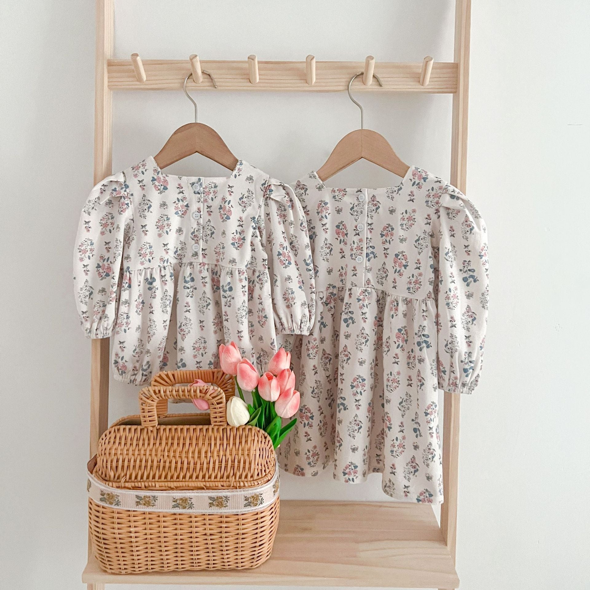 A cute Floral Square Neck Lantern Long Sleeve Onesie and Dress for baby girls, featuring a floral pattern in white and red colors.