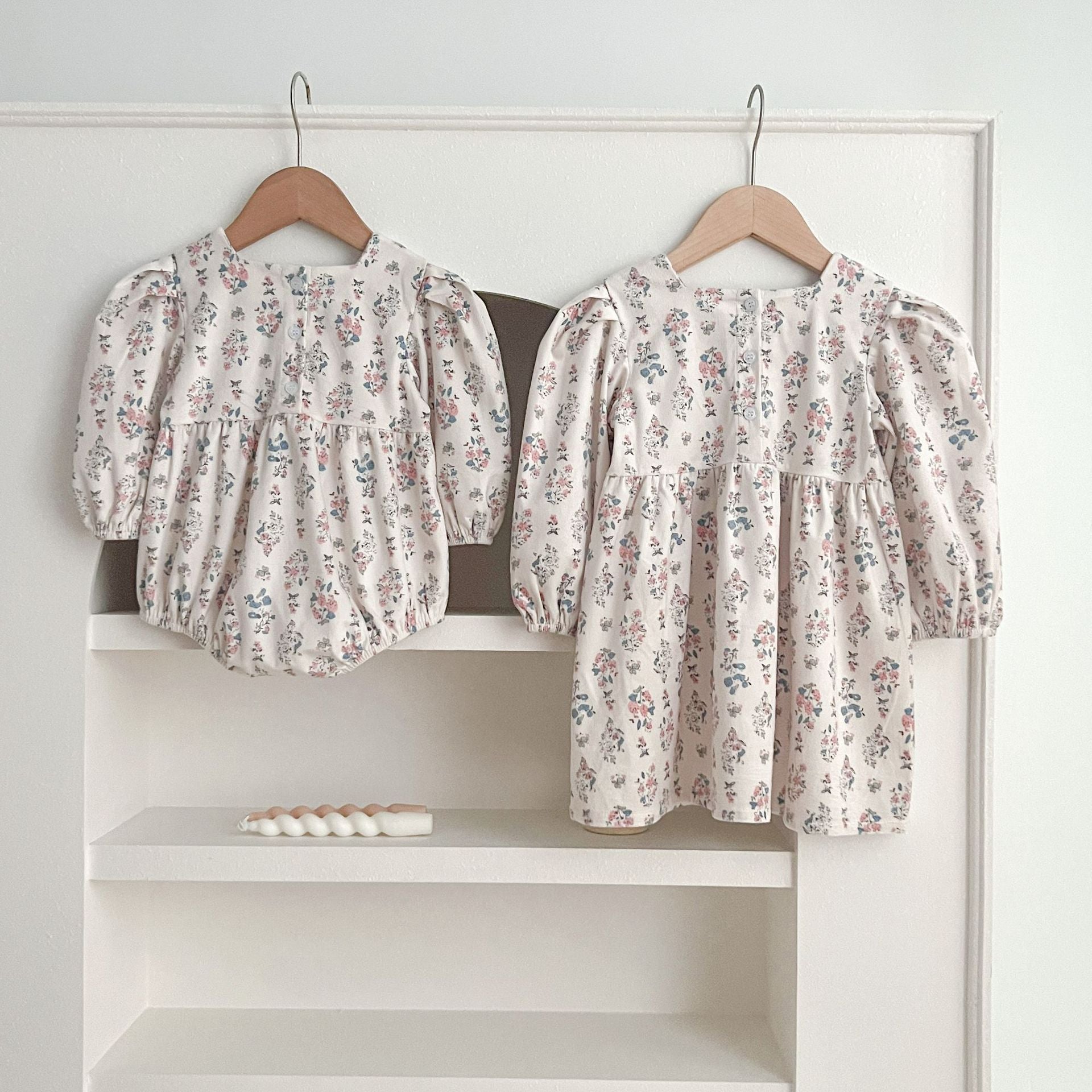 A cute Floral Square Neck Lantern Long Sleeve Onesie and Dress for baby girls, featuring a floral pattern in white and red colors.