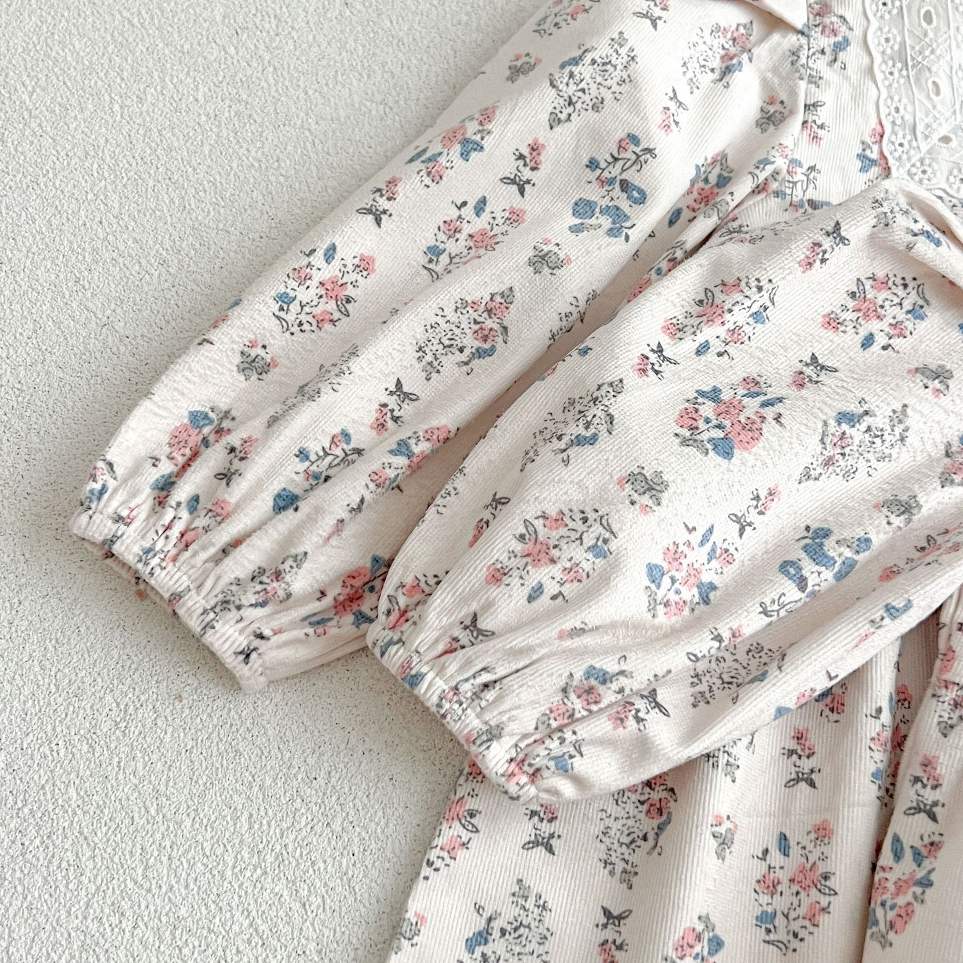 A cute Floral Square Neck Lantern Long Sleeve Onesie and Dress for baby girls, featuring a floral pattern in white and red colors.