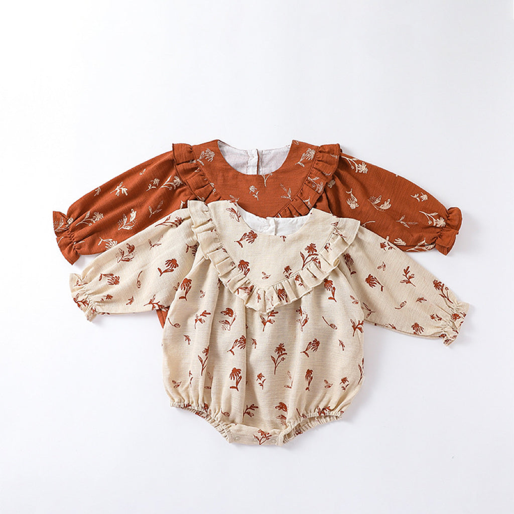 A cute vintage-style onesie for baby girls featuring a floral pattern in beige and brown colors, made from soft cotton fabric.