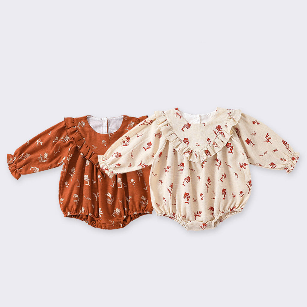 A cute vintage-style onesie for baby girls featuring a floral pattern in beige and brown colors, made from soft cotton fabric.