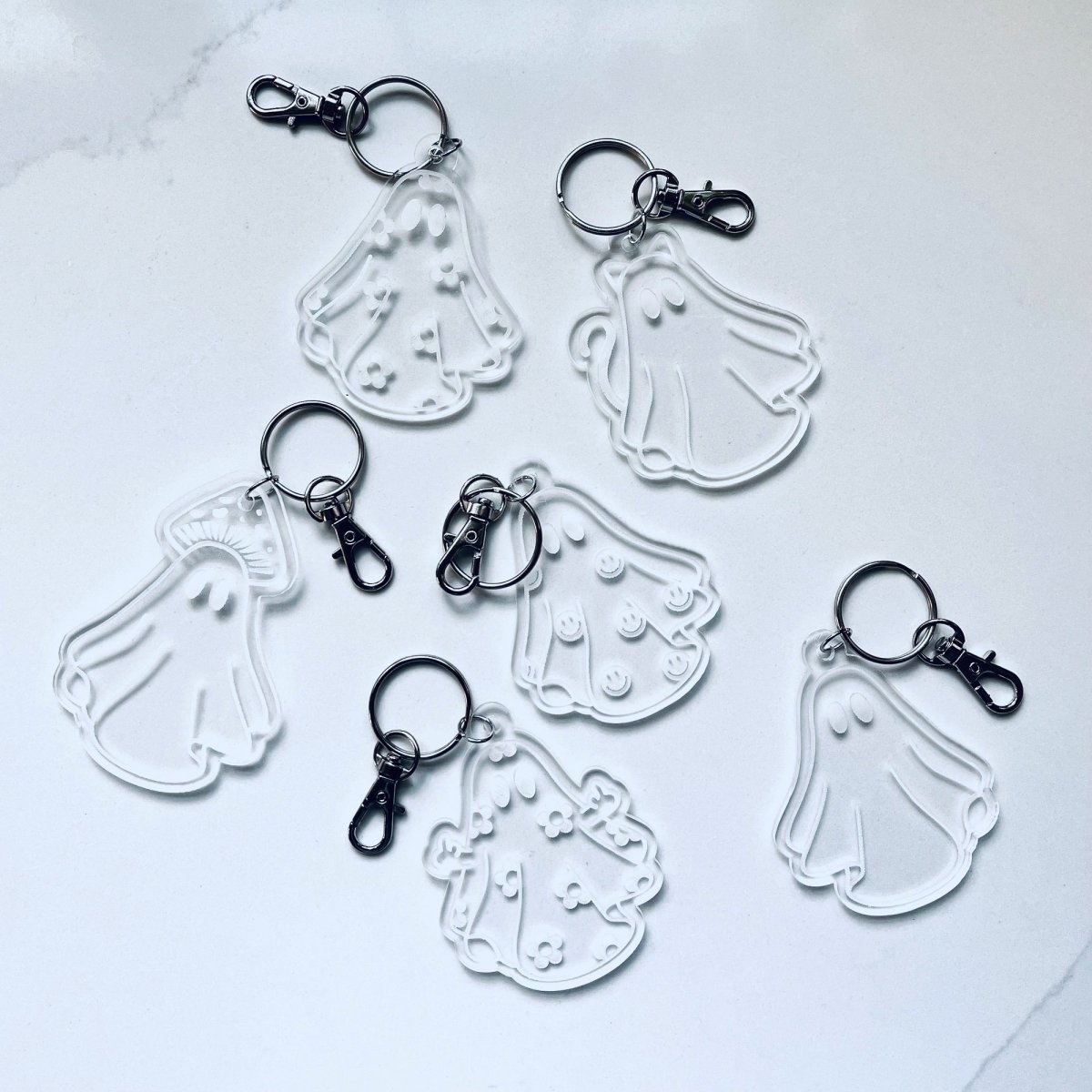 Daisy Ghost Keychain featuring a cute laser-engraved ghost design in clear acrylic, available in cute and sassy options.