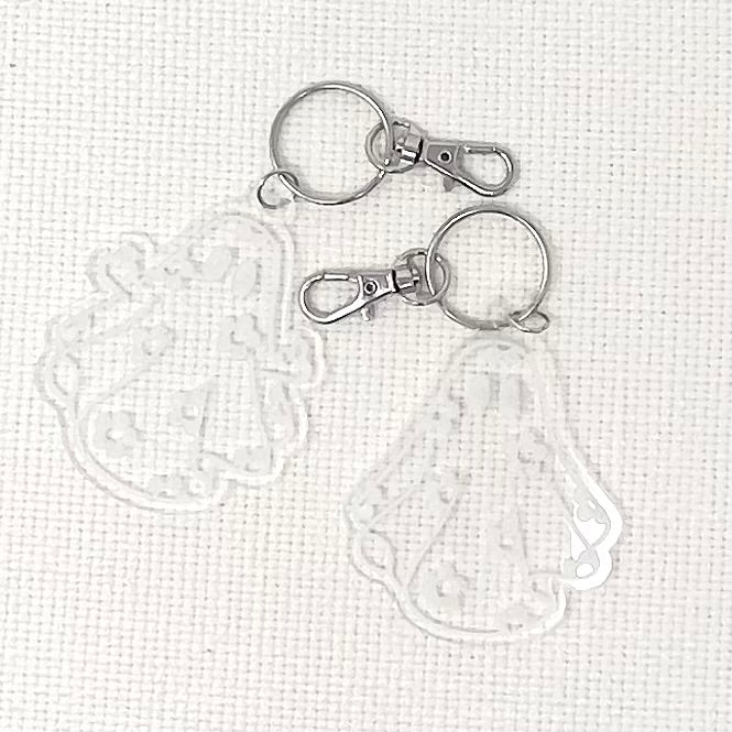 Daisy Ghost Keychain featuring a cute laser-engraved ghost design in clear acrylic, available in cute and sassy options.