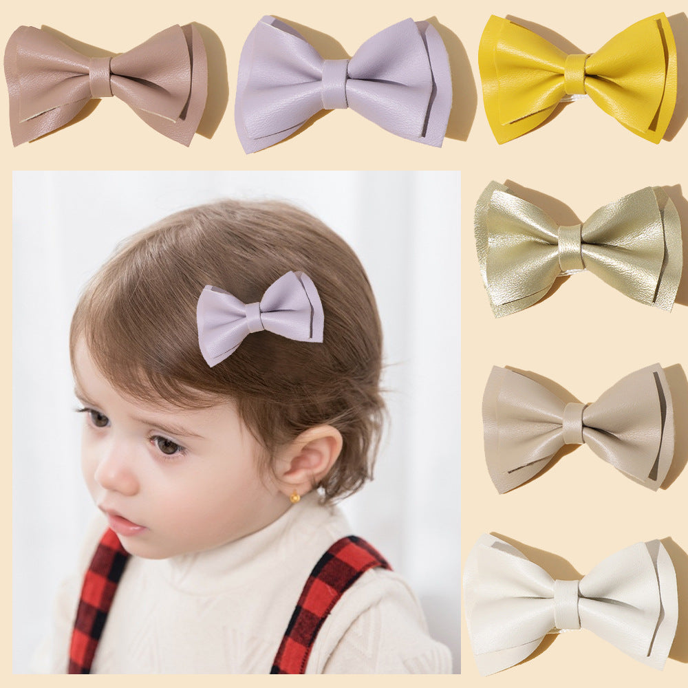 Handmade cloth bow tie hair clips for girls in various colors including white, purple, yellow, khaki, gold, and brown.