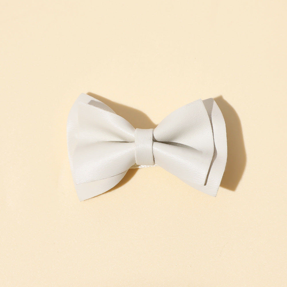 Handmade cloth bow tie hair clips for girls in various colors including white, purple, yellow, khaki, gold, and brown.