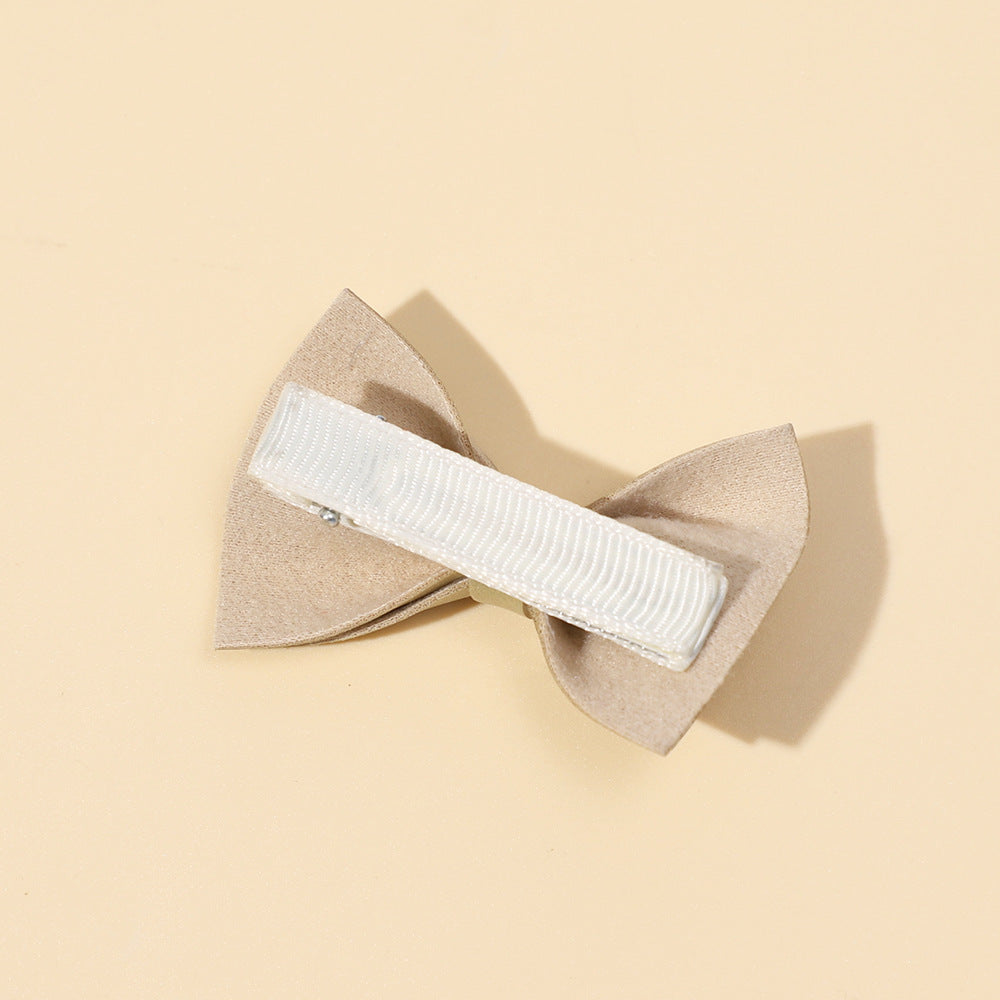 Handmade cloth bow tie hair clips for girls in various colors including white, purple, yellow, khaki, gold, and brown.