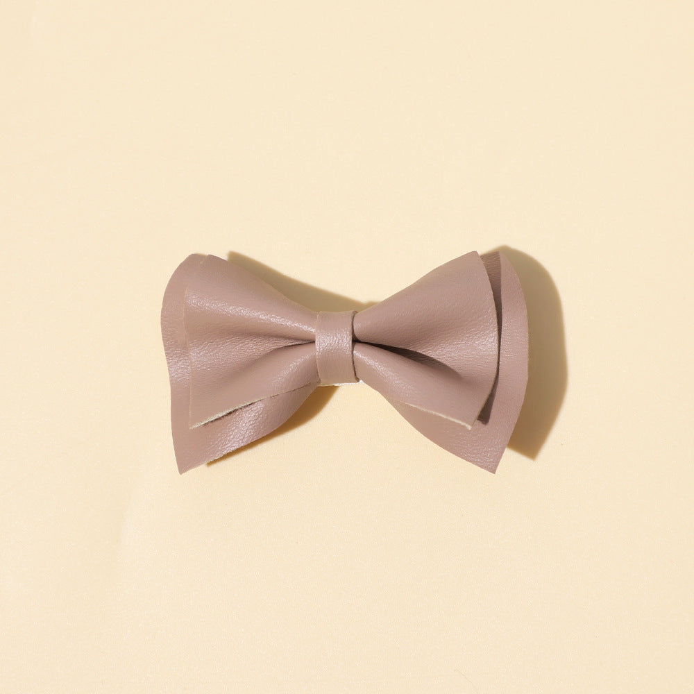 Handmade cloth bow tie hair clips for girls in various colors including white, purple, yellow, khaki, gold, and brown.