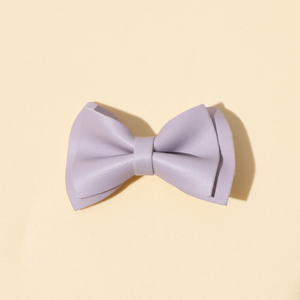 Handmade cloth bow tie hair clips for girls in various colors including white, purple, yellow, khaki, gold, and brown.