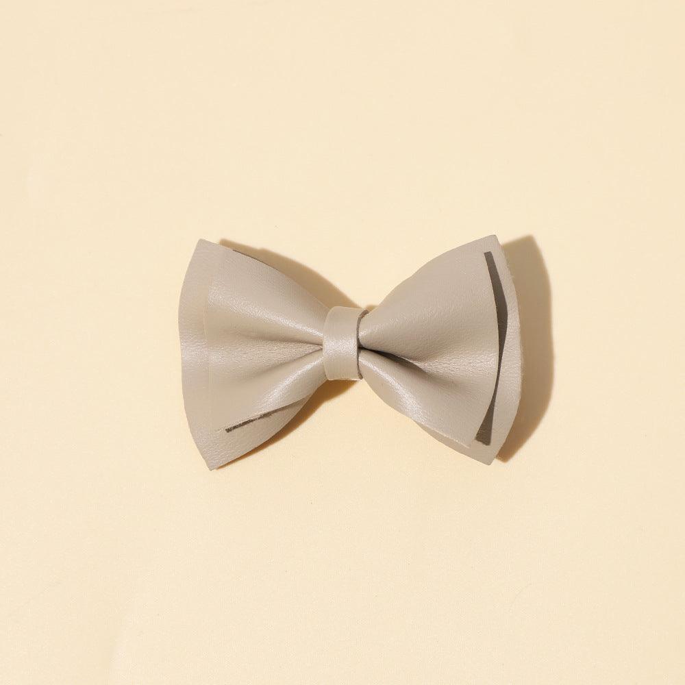 Handmade cloth bow tie hair clips for girls in various colors including white, purple, yellow, khaki, gold, and brown.