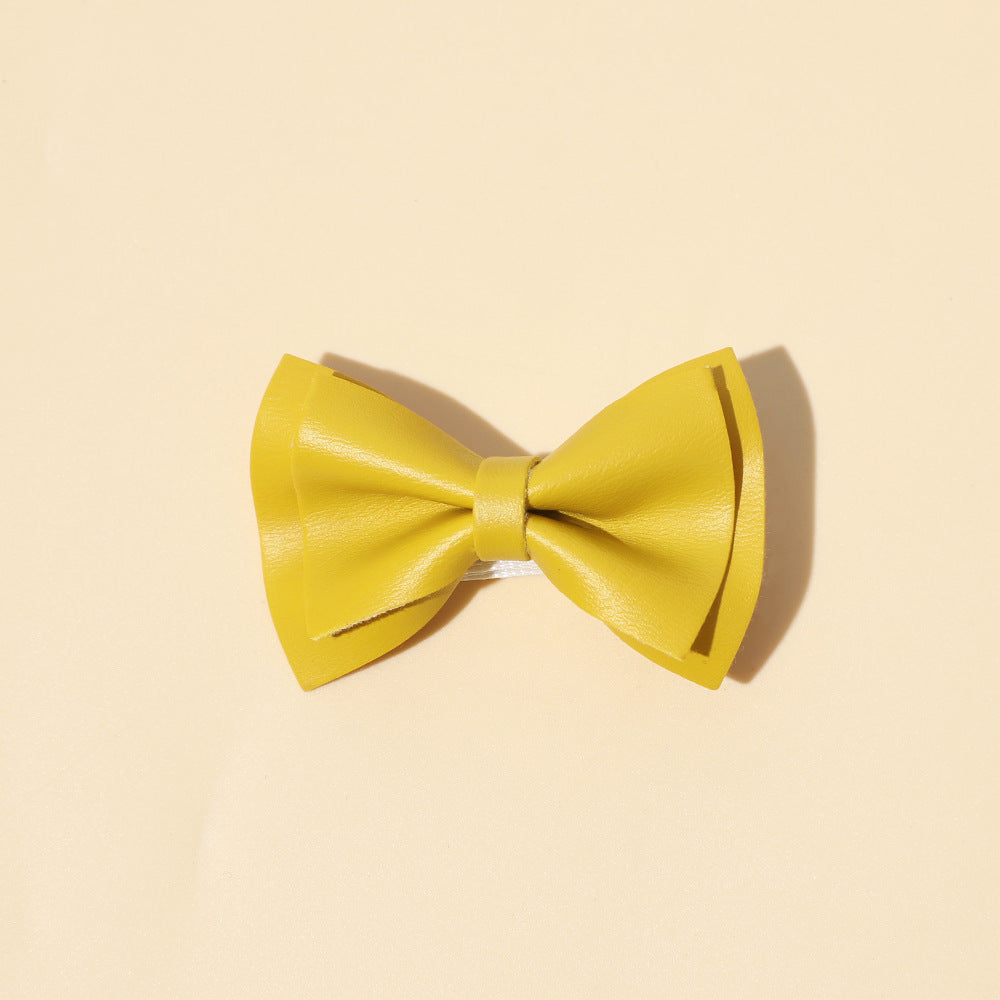 Handmade cloth bow tie hair clips for girls in various colors including white, purple, yellow, khaki, gold, and brown.