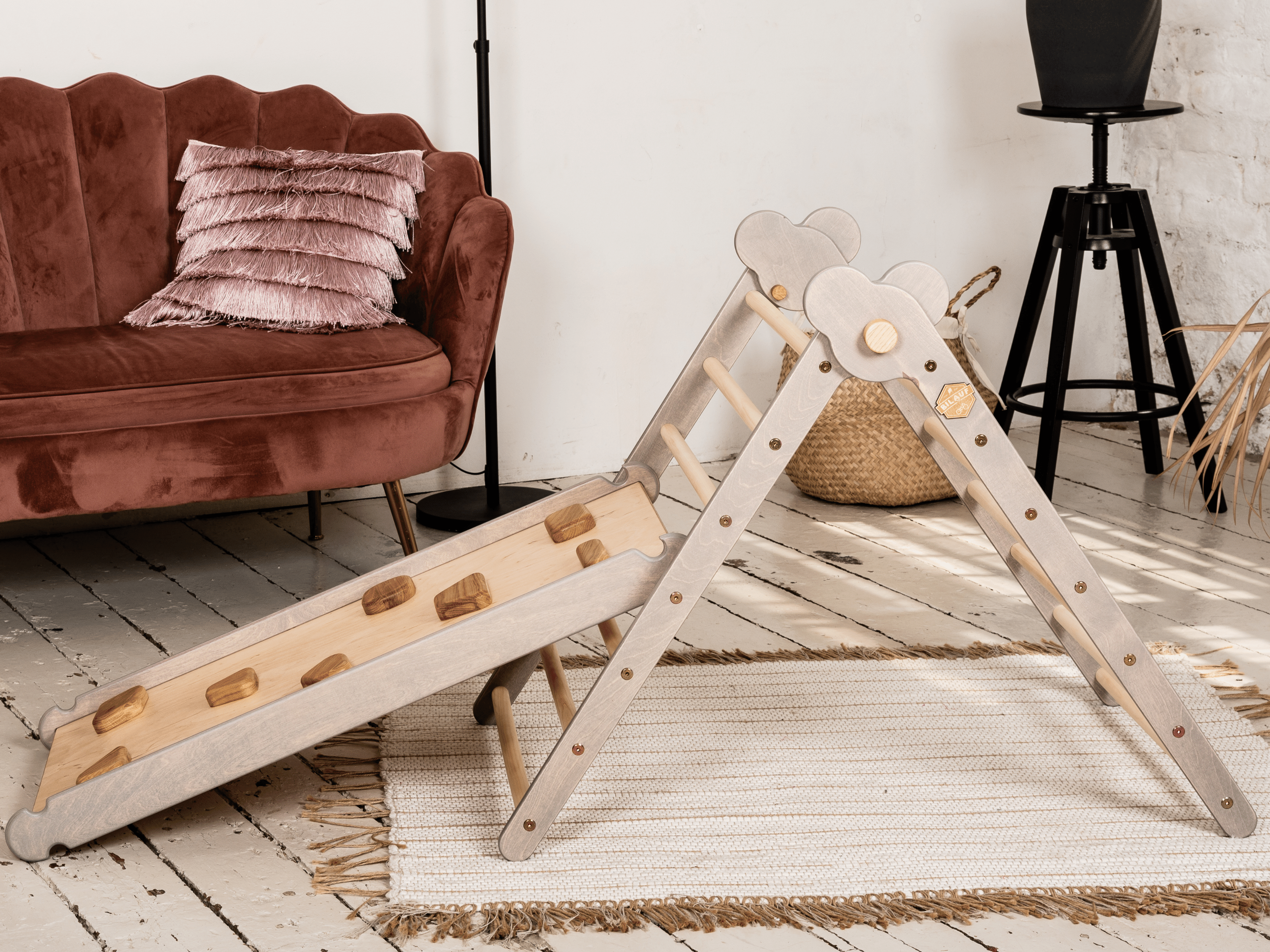 Gray Teddy Rock climbing set featuring a climbing triangle, ramp, and balance board made from natural wood, designed for children.