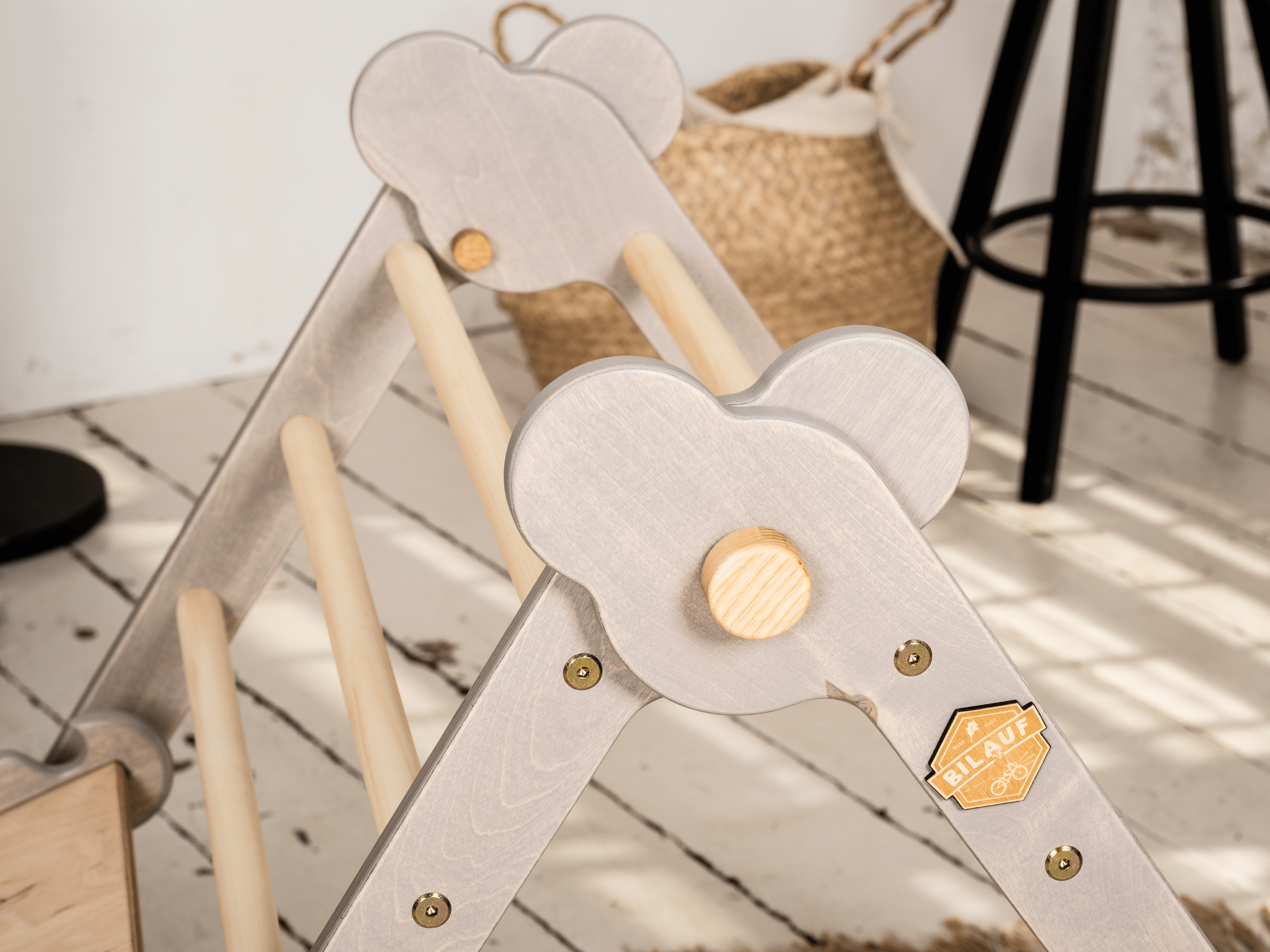 Gray Teddy Rock climbing set featuring a climbing triangle, ramp, and balance board made from natural wood, designed for children.