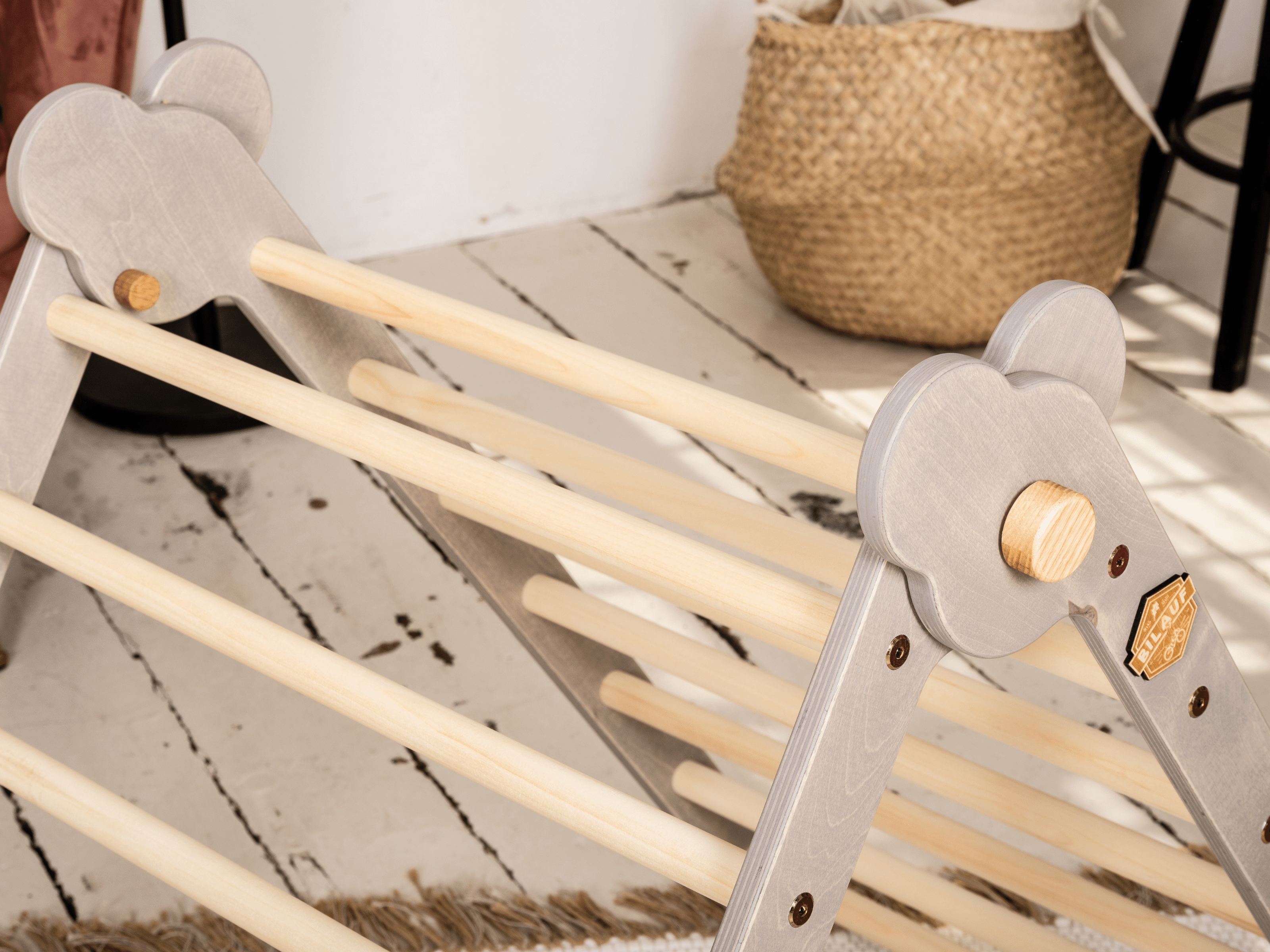 Gray Teddy Rock climbing set featuring a climbing triangle, ramp, and balance board made from natural wood, designed for children.