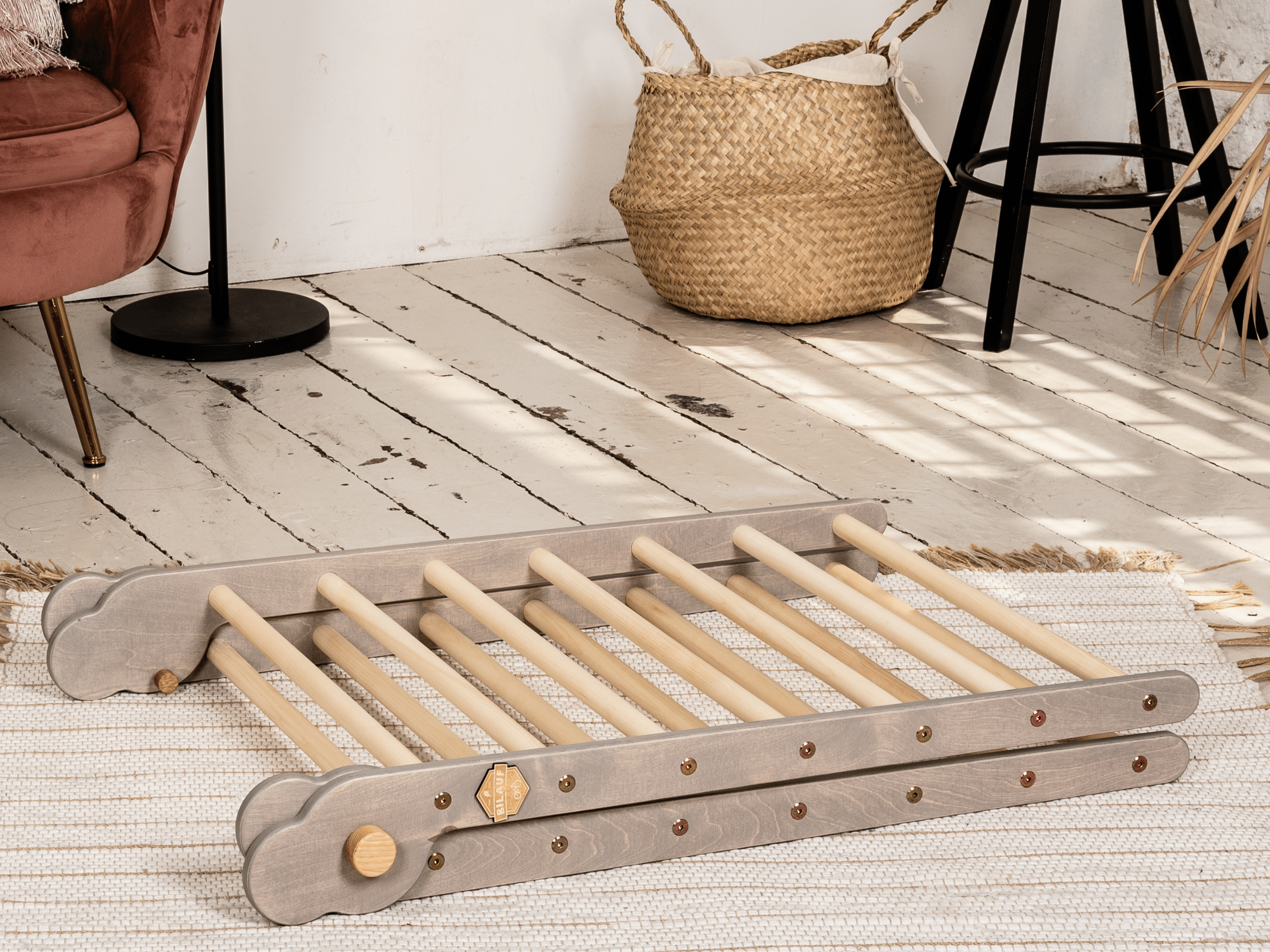 Gray Teddy Rock climbing set featuring a climbing triangle, ramp, and balance board made from natural wood, designed for children.