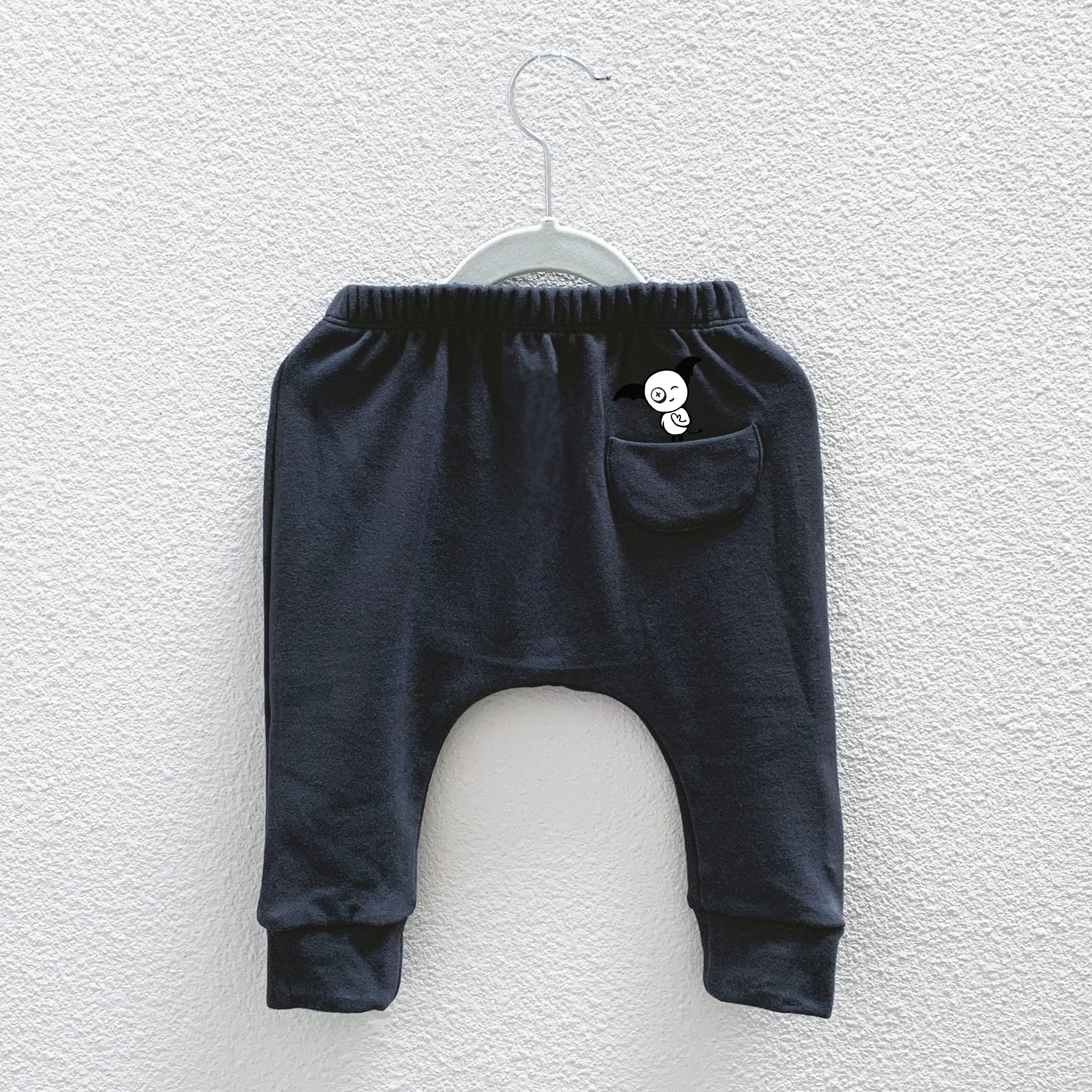 Charcoal Hammer Pants featuring a unique monster peek-a-boo back pocket and drop crotch harem style, made from a soft cotton-polyester blend.