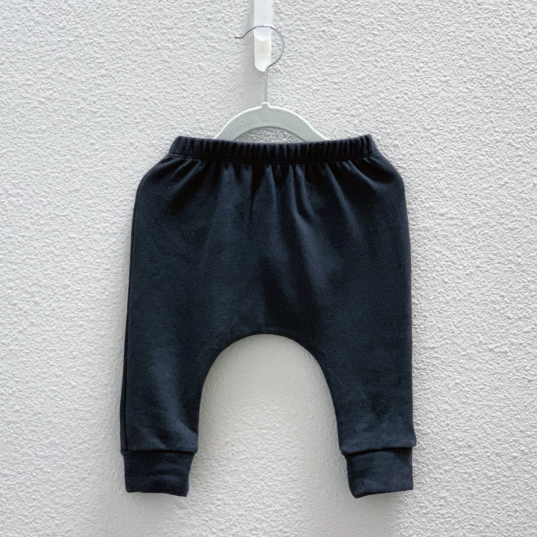 Charcoal Hammer Pants featuring a unique monster peek-a-boo back pocket and drop crotch harem style, made from a soft cotton-polyester blend.