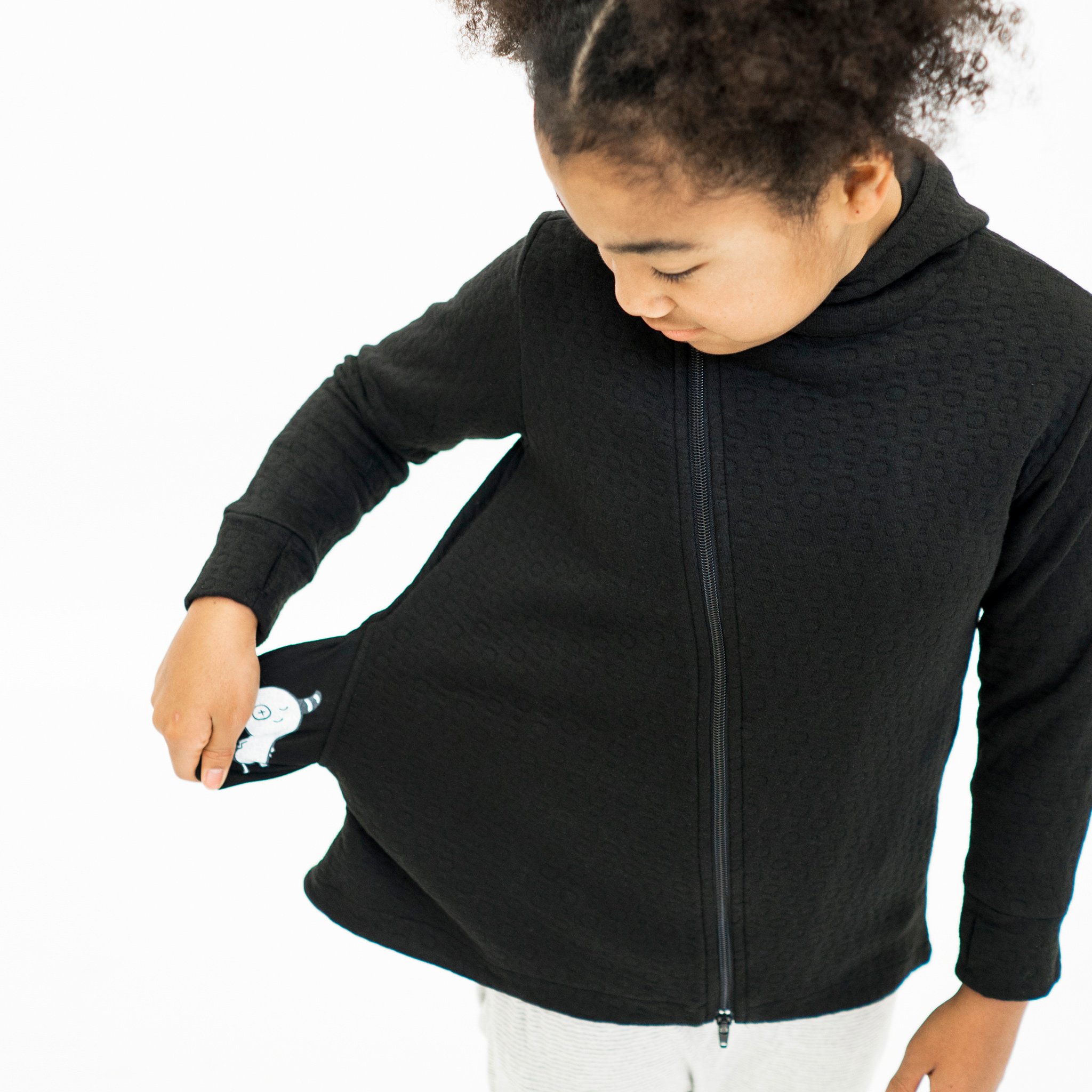 Youth Hi-Lo Quilted Hoodie featuring playful circle quilted pattern and hidden monster pocket, designed for comfort and style.