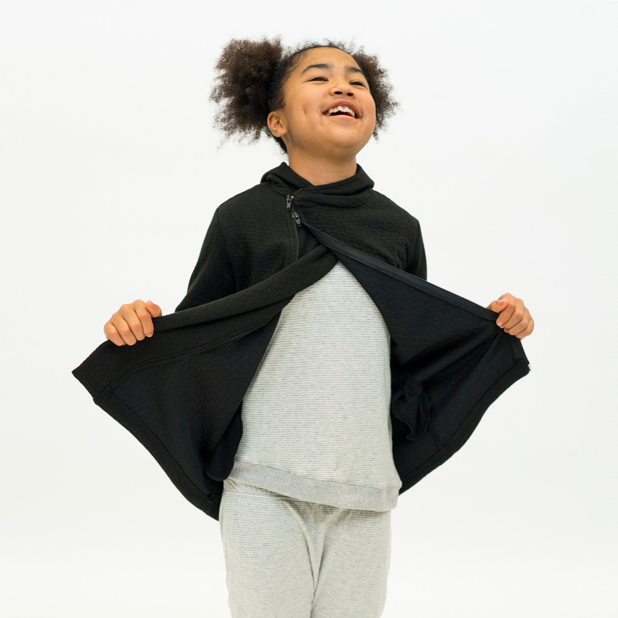 Youth Hi-Lo Quilted Hoodie featuring playful circle quilted pattern and hidden monster pocket, designed for comfort and style.