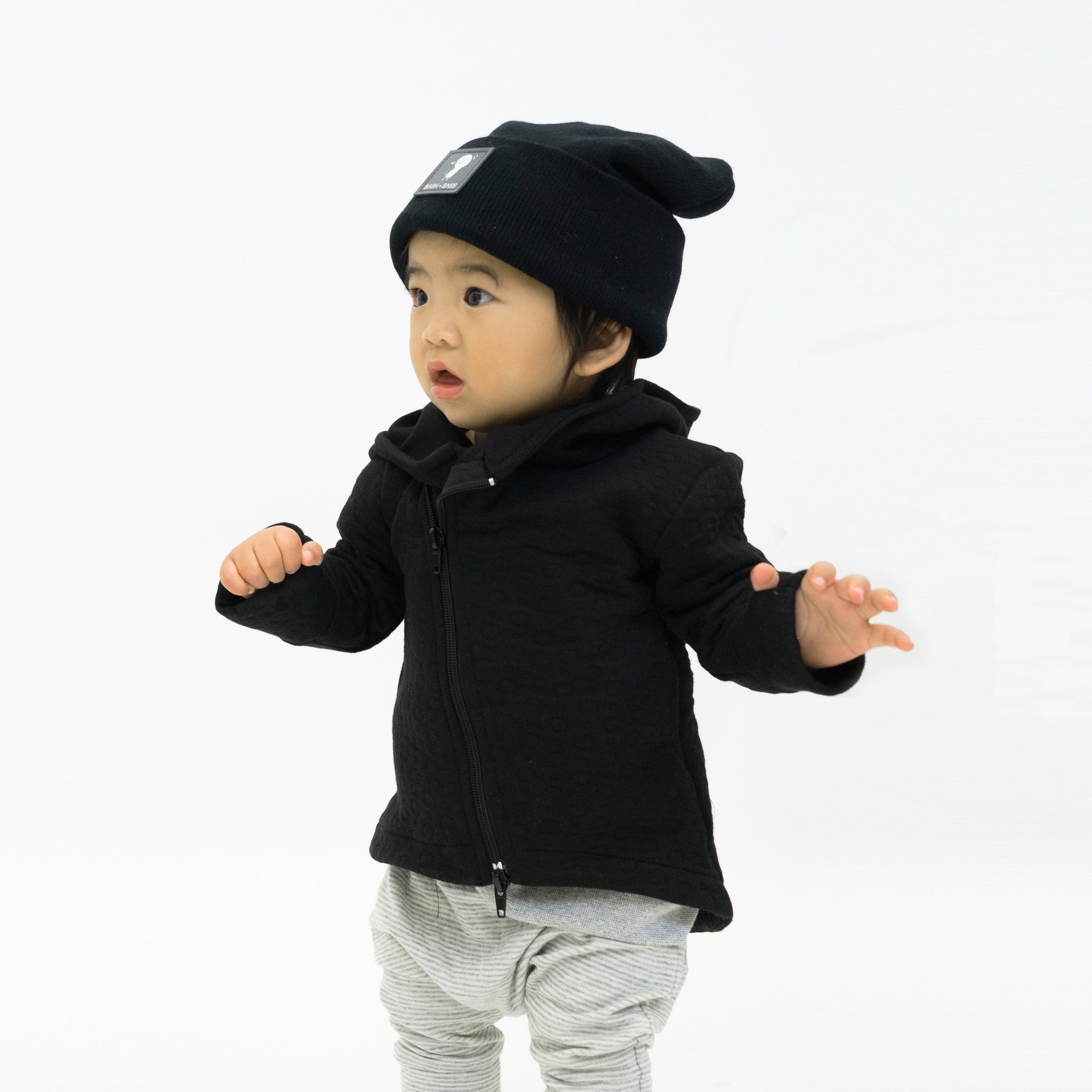 Hi-Lo Quilted Hoodie featuring a playful design with a monster peek-a-boo pocket and circle quilted pattern.