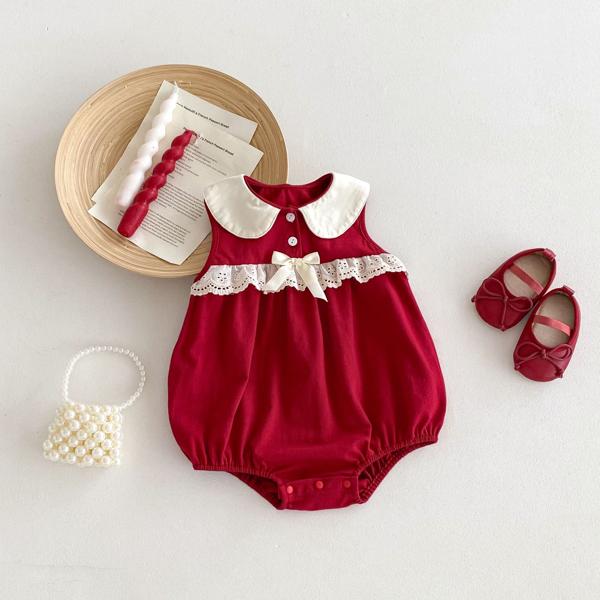 A vibrant red sleeveless dress for baby girls featuring a stylish patchwork design, perfect for summer wear.