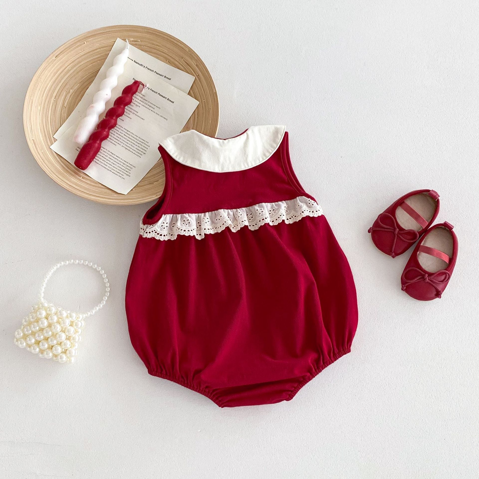 A vibrant red sleeveless dress for baby girls featuring a stylish patchwork design, perfect for summer wear.