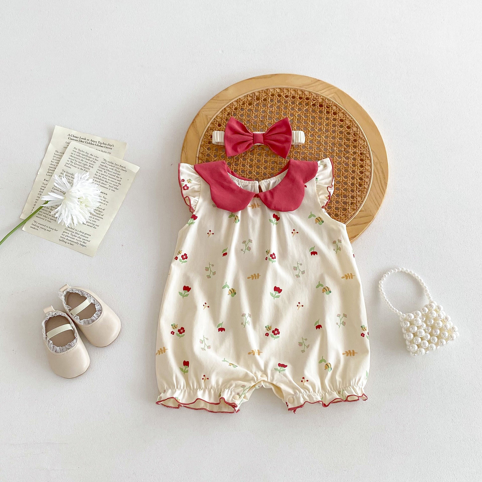 A vibrant red sleeveless dress for baby girls featuring a floral pattern, perfect for summer wear.