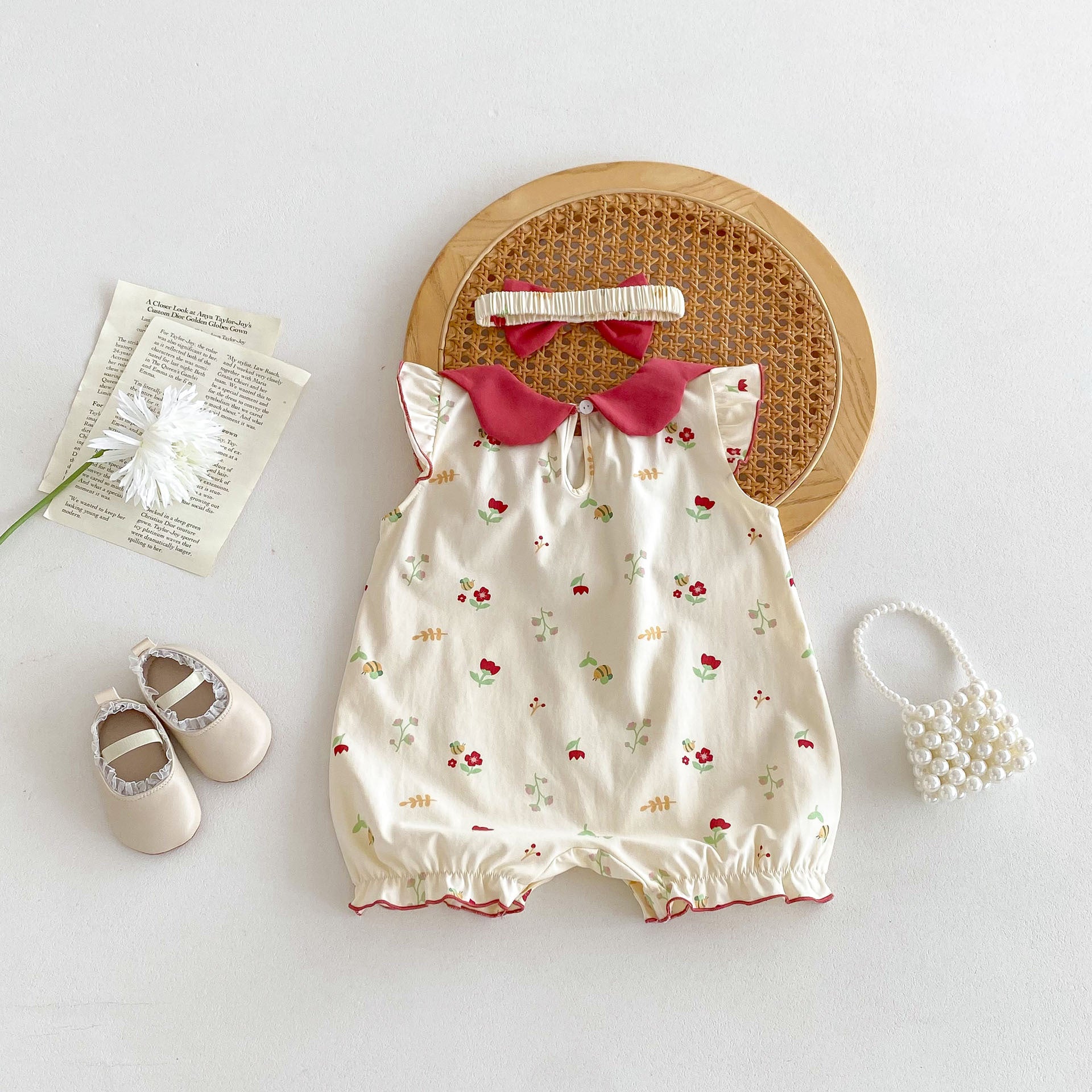 A vibrant red sleeveless dress for baby girls featuring a floral pattern, perfect for summer wear.