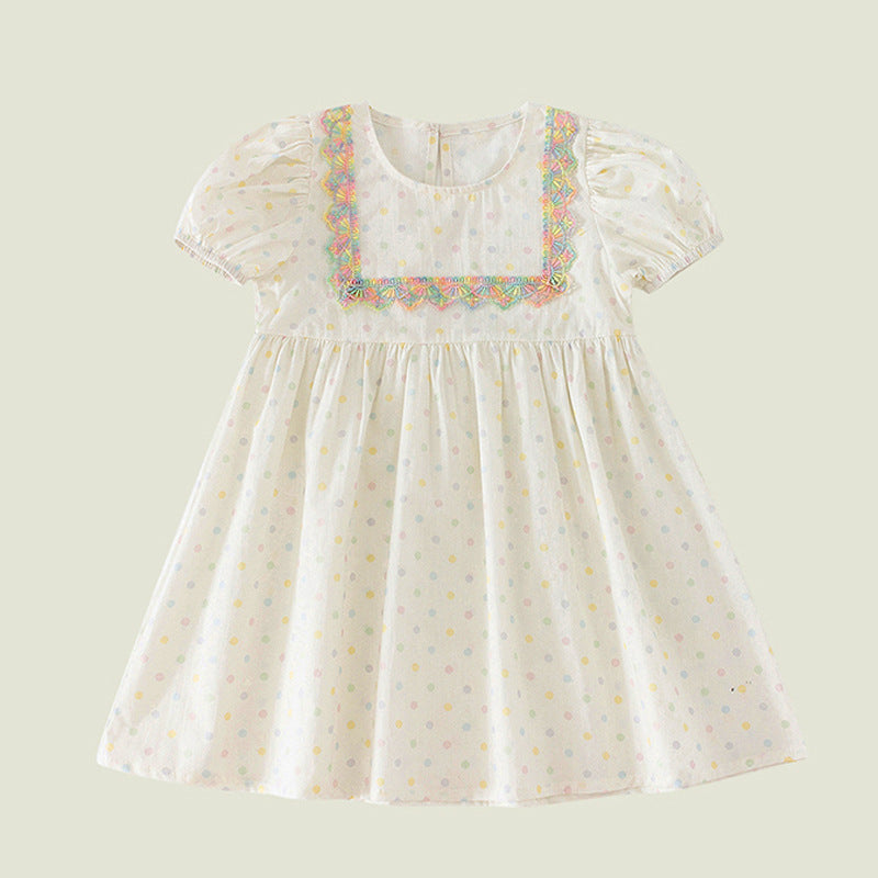 A beige summer dress for girls featuring short sleeves and a playful polka dot pattern, perfect for warm weather outings.