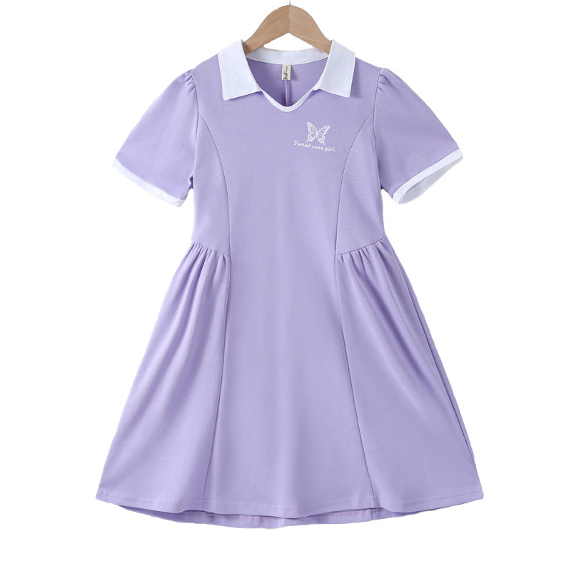 A vibrant purple short-sleeve shirt for girls, made from soft cotton, featuring a trendy letter pattern, perfect for summer activities.