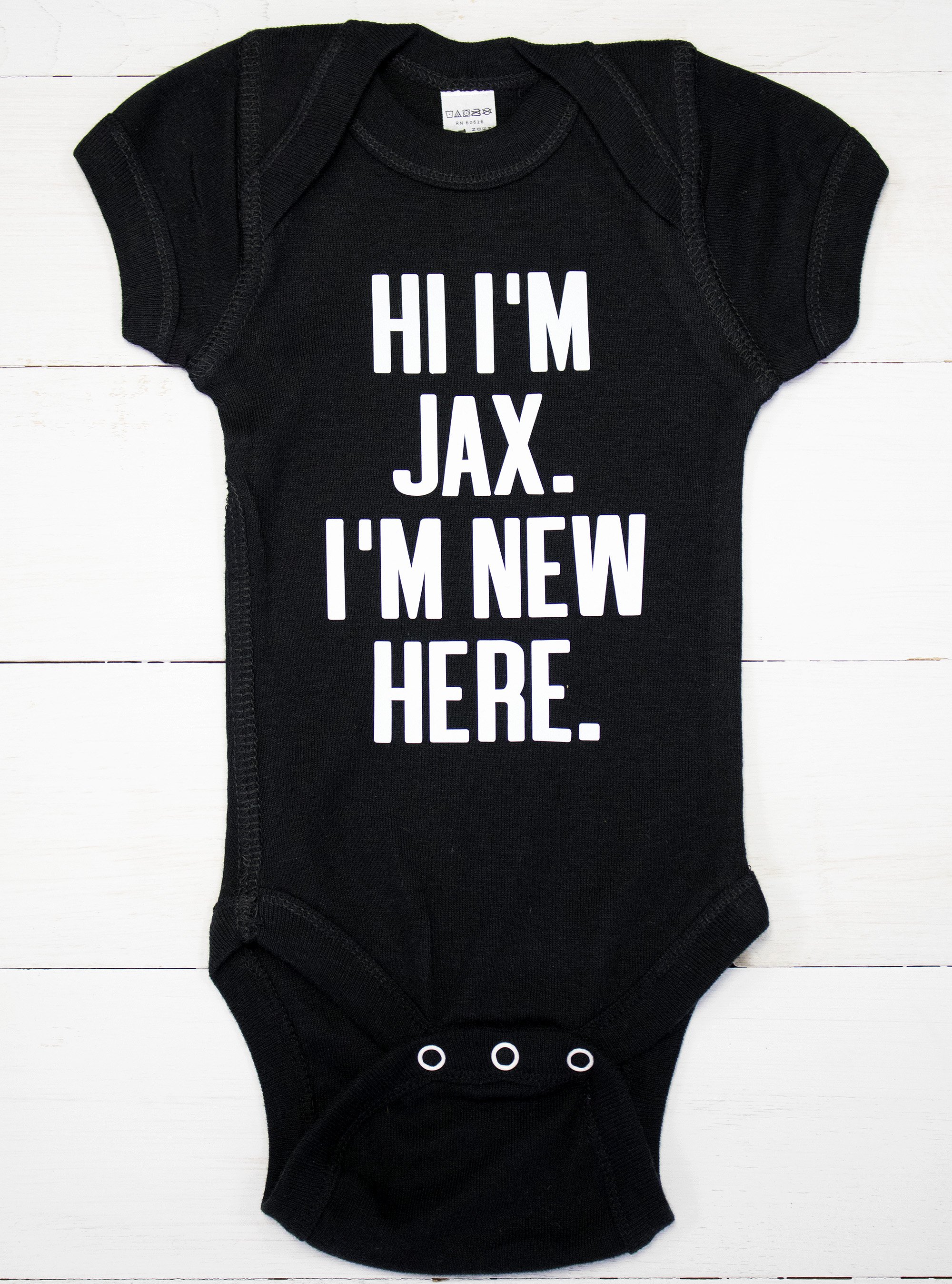 Customizable I'm New Here Baby Bodysuit in various colors, featuring a cute design for newborns.