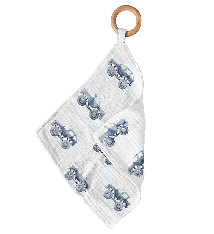 Indigo Monster Trucks Cotton Newcastle Teether featuring a soft cotton blankie and a removable beach wood ring for teething relief.